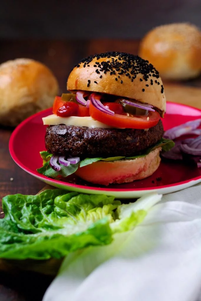 Rich, hearty and seriously tasty, Black Bean Veggie Burgers are so flavoursome and so good. Packed full of goodness with beans, oats, walnuts and sunflower seeds, these burgers are a real crowd-pleaser.