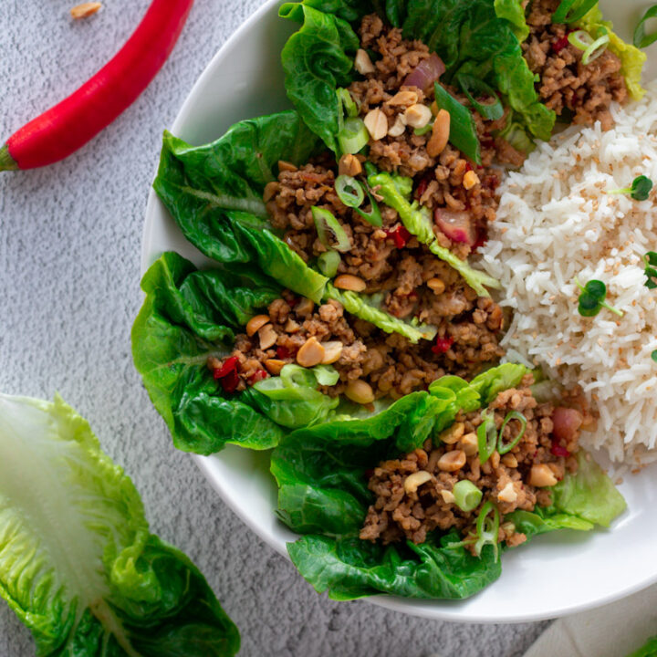 San Choy Bow in a bowl with rice.