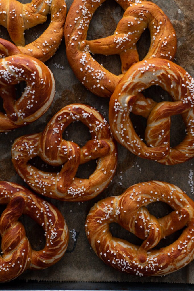 Cooked pretzels on a baking tray.