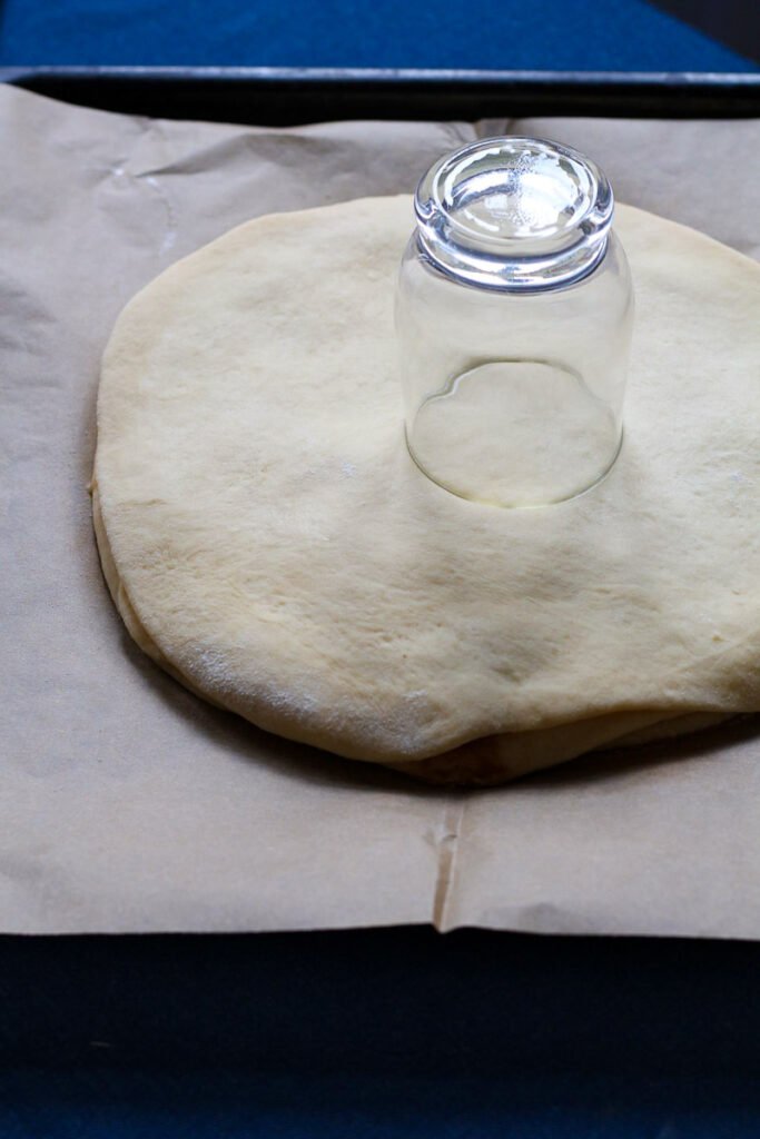 A glass on top of Cinnamon Star Bread dough.