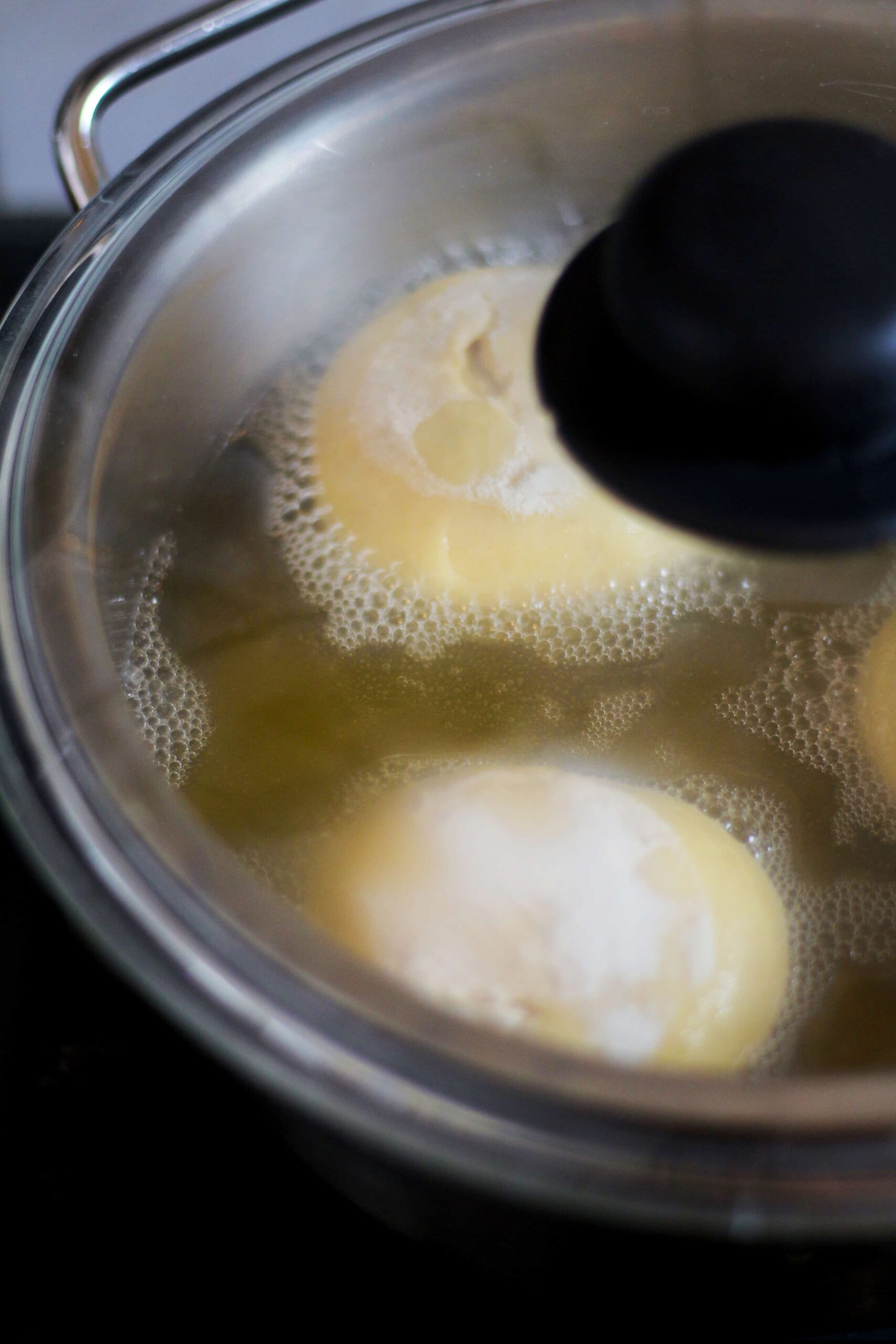 Krapfen cooking in oil.