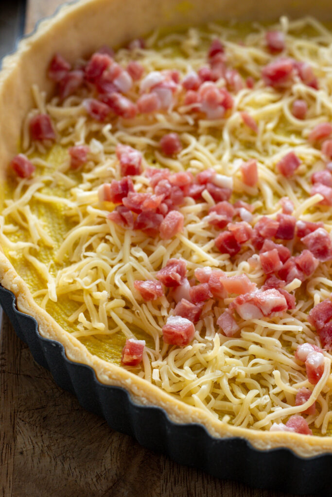 Bacon and cheese inside a tart shell.