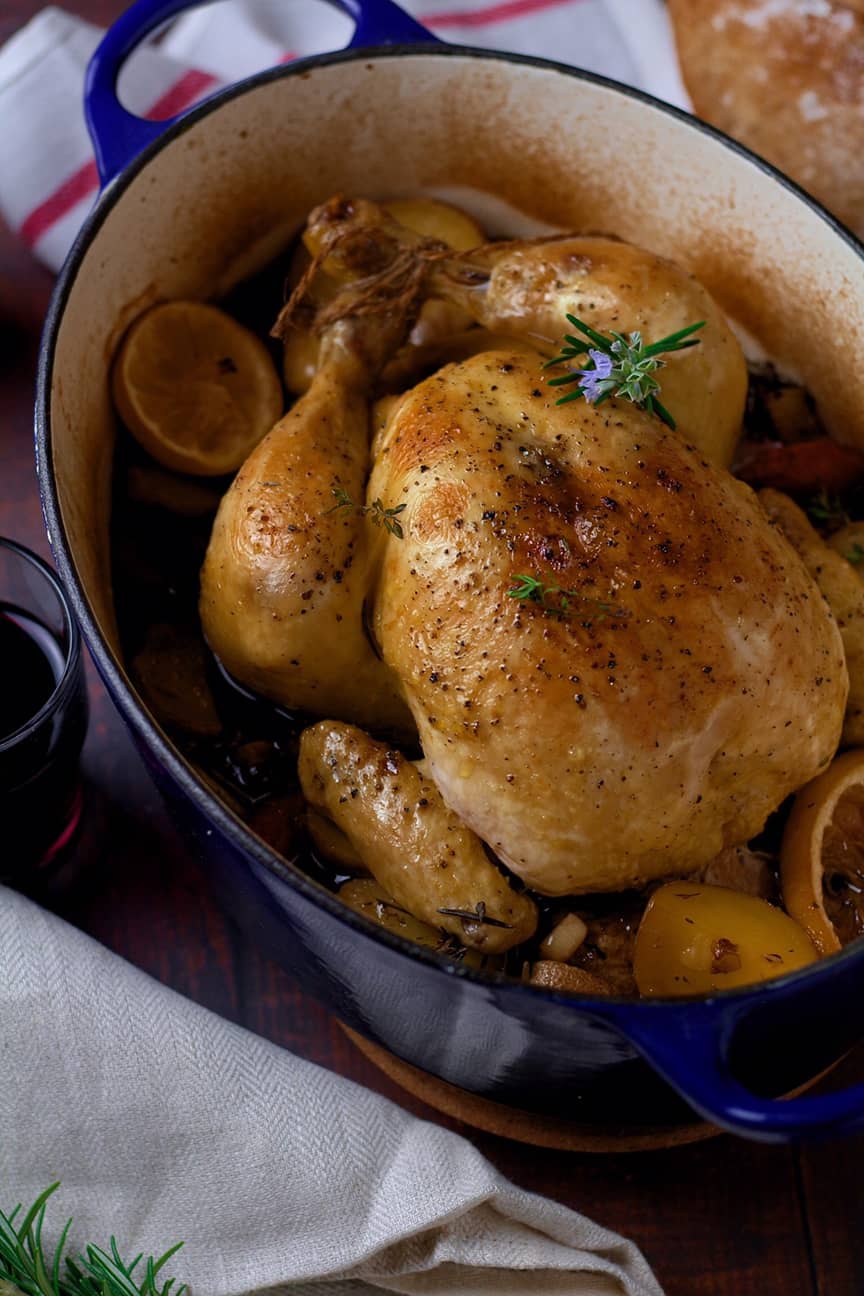 French Pot Roast Chicken or Poulet au Pot in an enamelled Dutch oven.