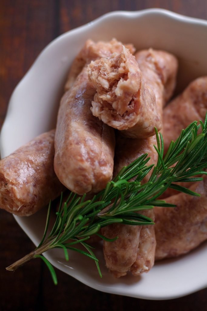 Fresh Italian sausages with rosemary.
