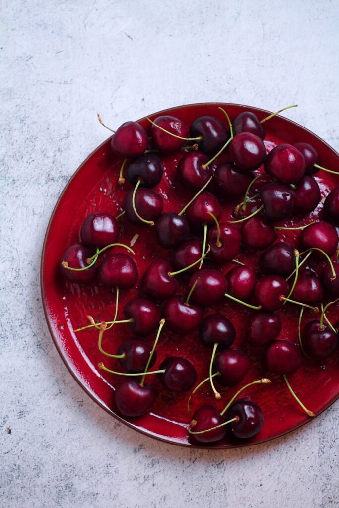 Cherries on Red Plate