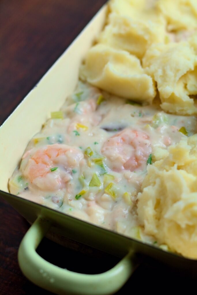 Creamy Smoked Fish Pie showing filling under mashed potatoes.