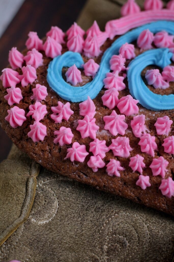 A closeup of a decorated gingerbread heart.