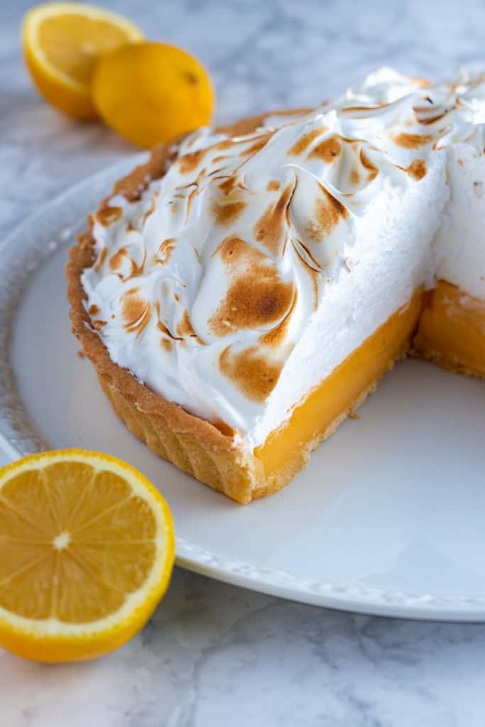 A close up of a sliced Lemon Meringue Pie seen from above.