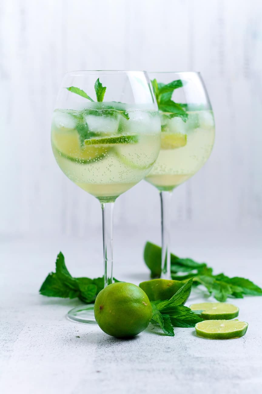 Wildly popular across Europe, the Hugo Spritz cocktail is a refreshing mixture of lime, mint, elderflower and sparkling wine. Served over ice in a large wine glass, this is the perfect drink on a sunny day.