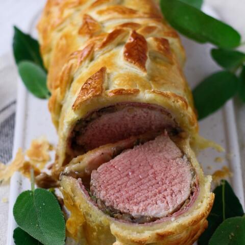 Juicy, perfectly cooked pork tenderloin, wrapped in prosciutto, mushrooms and buttery puff pastry. This is truly the Perfect Pork Wellington, my dinner party secret weapon. Better yet, it is even easier to make than it looks!