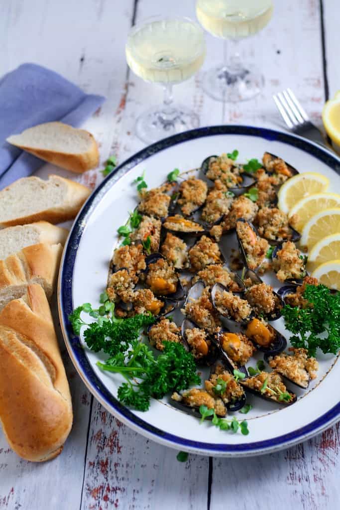 Garlic Butter Mussels au gratin or as the Italians call them Cozze al Forno are a fantastic starter or light meal for two. So quick and easy to prepare they are packed with Mediterranean flavour.