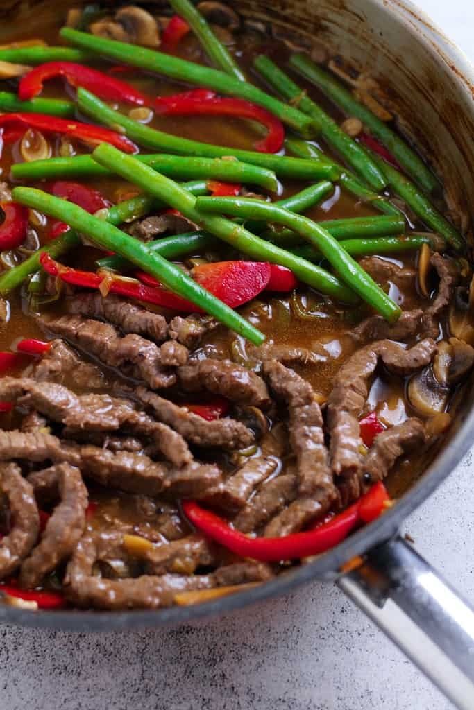 Ginger beef stir fry cooking in the pan.