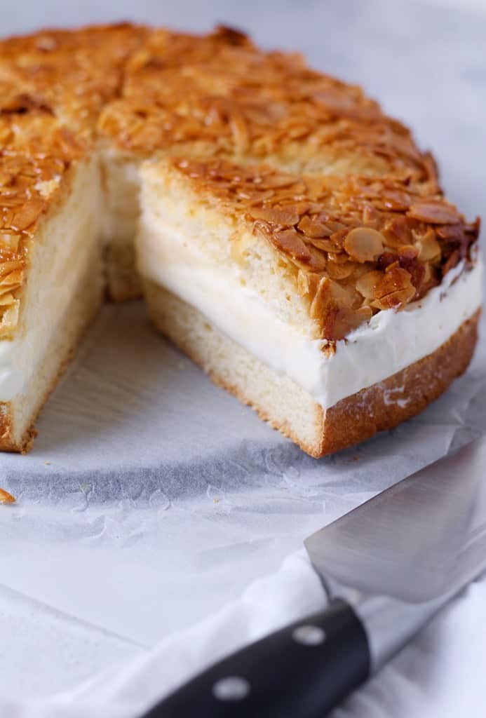 A photograph of a German Bee Sting Cake showing the filling and layers of the cake with a slice taken out.