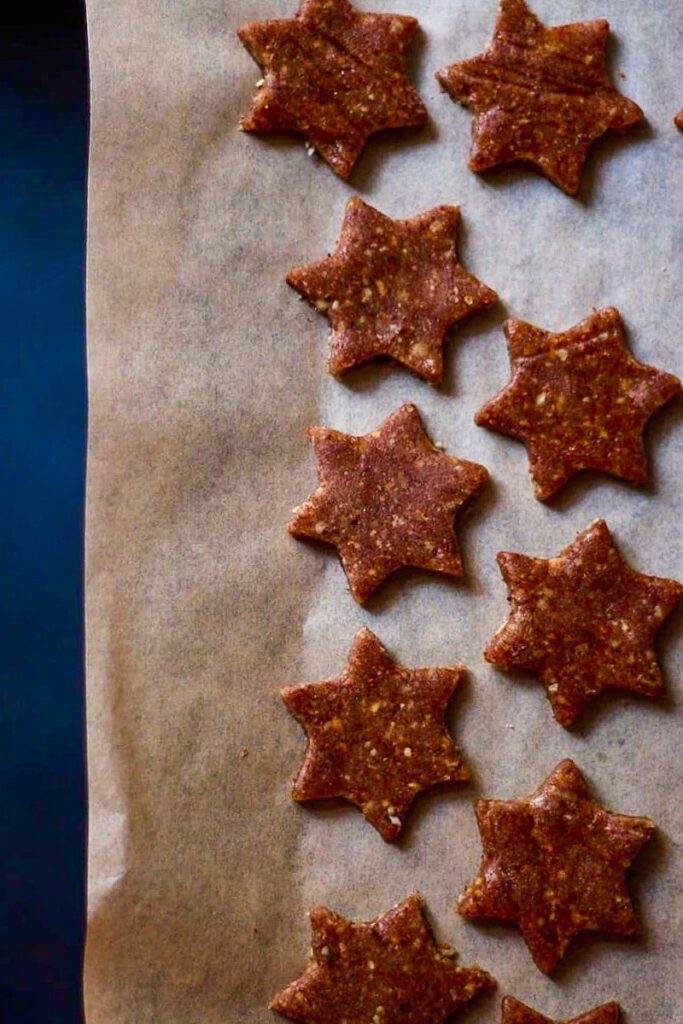 Unbaked cinnamon stars on a baking sheet.