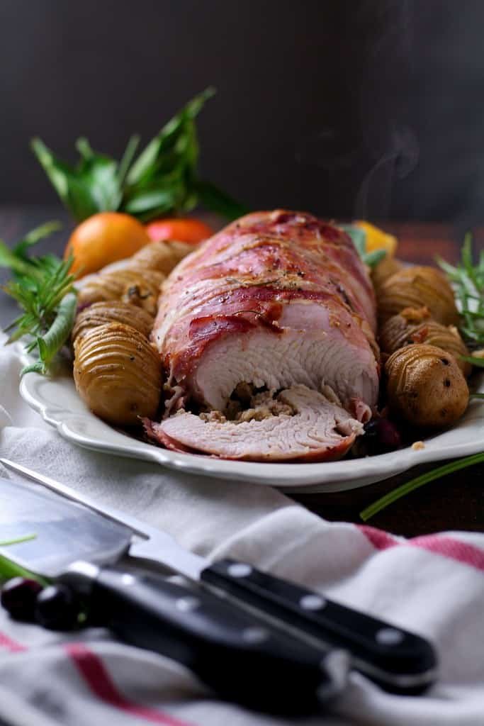 Sliced stuffed turkey breast revealing the traditional sausage stuffing within.