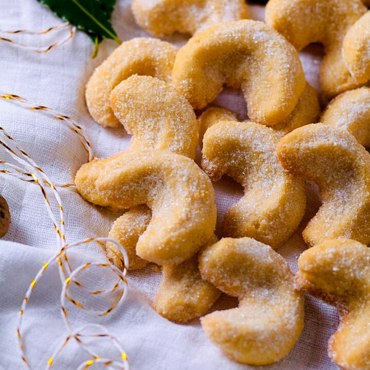 A close up photograph of baked Vanillekipferl cookies.