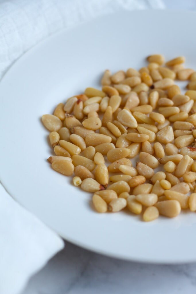 Toasted pine nuts on a plate