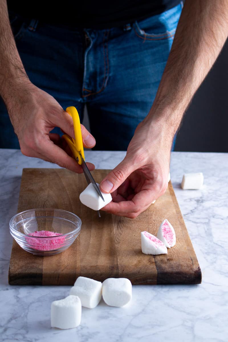 Cutting marshmallows diagonally for Easter Bunny Cupcakes.