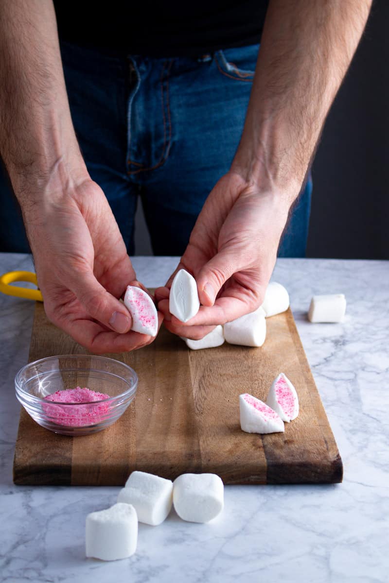 Jay Wadams showing marshmallows for Easter Bunny Cupcakes dipped in pink sugar.