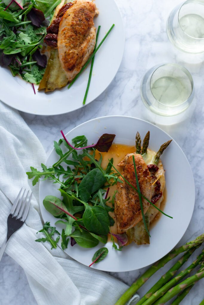 An easy-breezy dinner for springtime, Asparagus Stuffed Chicken Breasts are simple to prepare but look and taste fabulous. This is a brilliant recipe for an easy dinner party or Easter lunch.