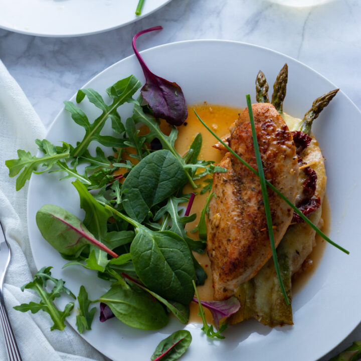 An easy-breezy dinner for springtime, Asparagus Stuffed Chicken Breasts are simple to prepare but look and taste fabulous. This is a brilliant recipe for an easy dinner party or Easter lunch.