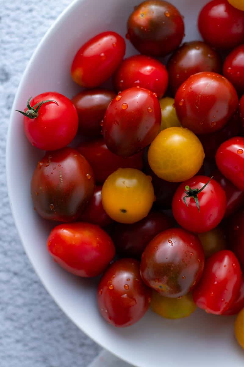 Fresh cherry tomatoes in a white bowl