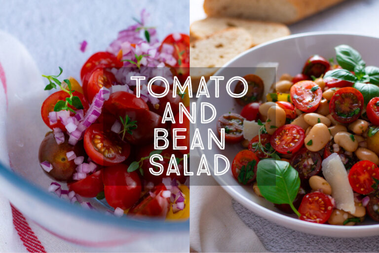 Cherry Tomato and White Bean Salad in a bowl with wooden salad servers and a baguette.