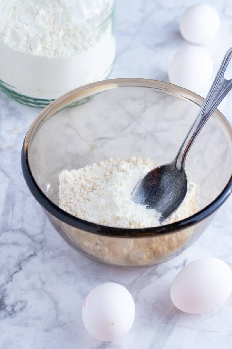 Flour and cornstarch in a bowl with fresh eggs