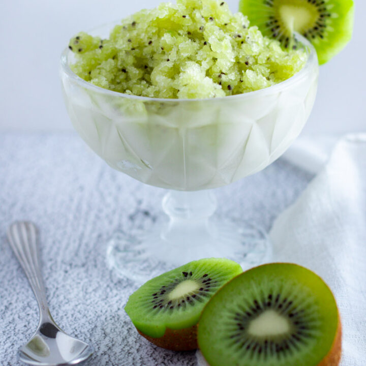 Kiwi or Kiwifruit Granita in a glass dish with fresh kiwifruit