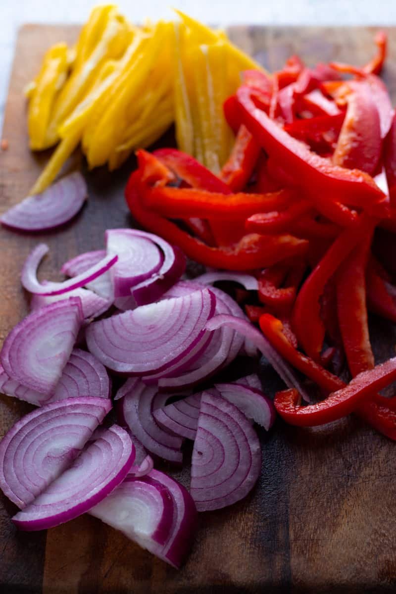Scliced red onion, red pepper and yellow pepper