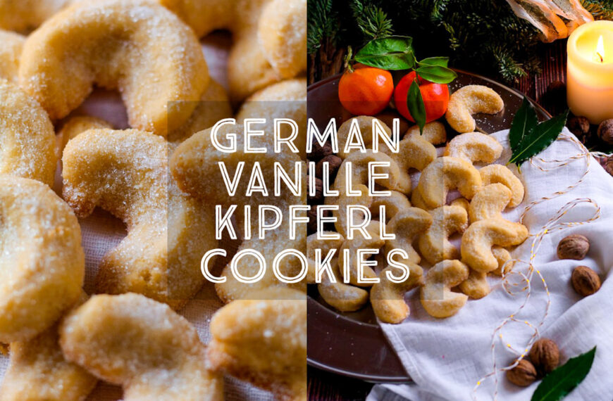 A plate of Vanillekipferl or Vanilla crescent cookies surrounded by Christmas decorations, walnuts, clementines and a candle.