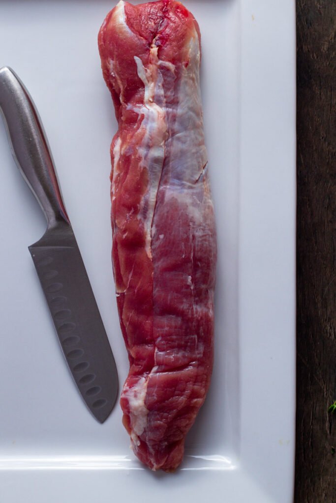 Pork tenderloin and a knife.