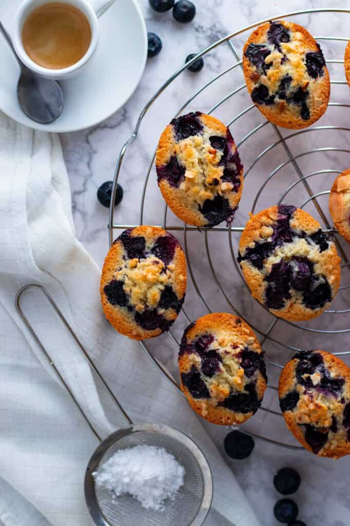 Blueberry Friands on a cooling rack.