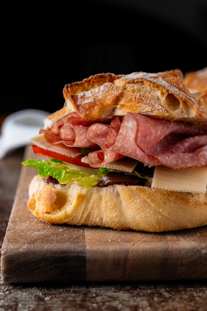 A filled roll with salami, cheese and salad made from overnight bread rolls.