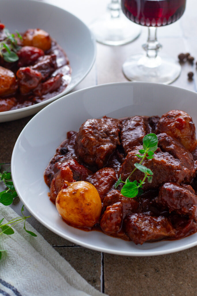 Stifado Greek Beef Stew in a bowl with red wine