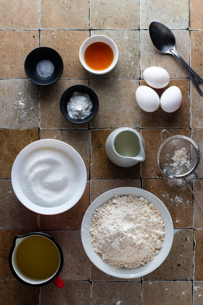 Ingredients for Vanilla Cake on a tiled surface.
