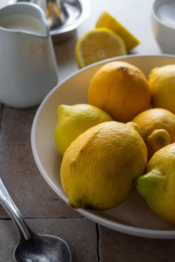 Lemons in a bowl on a kitchen counter.