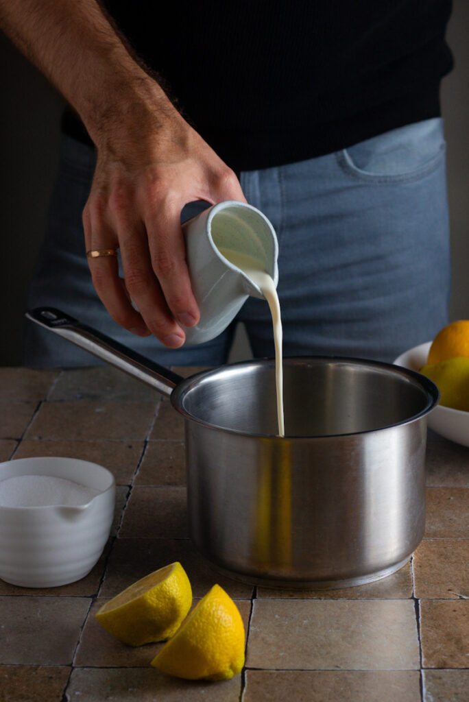 Jay Wadams pouring cream into a saucepan.