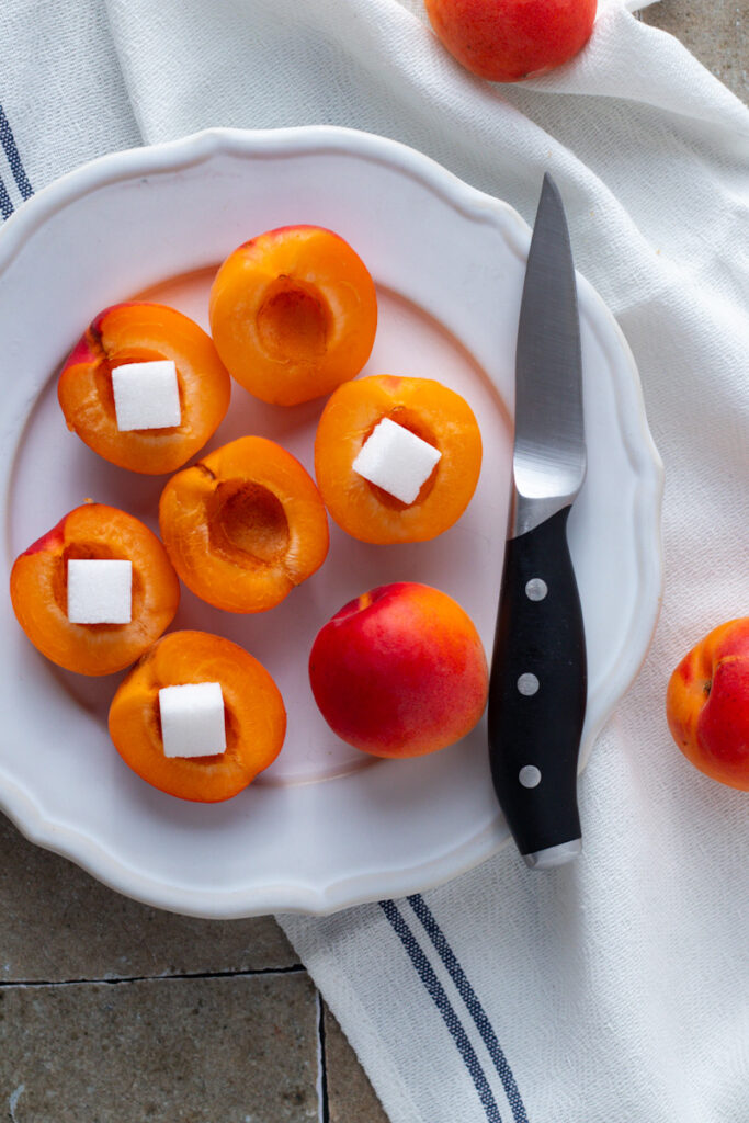 Halved apricots with sugar cubes.