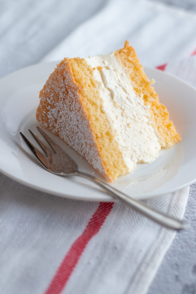 A slice of German Käse Sahne Torte on a plate.