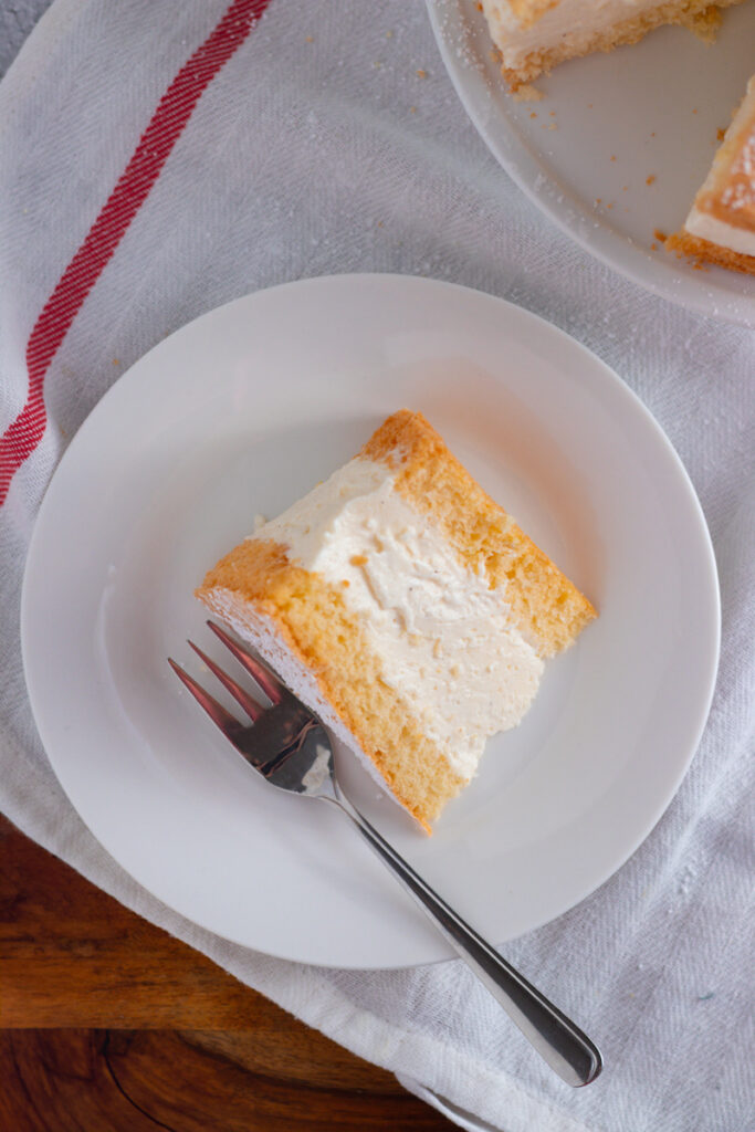 German Käse-Sahne Torte on a cake stand.