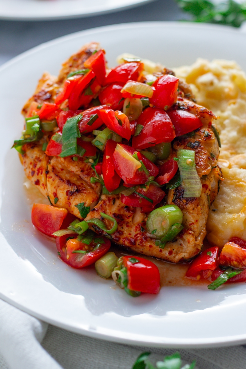 Herby Tomato Salsa Chicken Breasts on plates with potato and sweetcorn mash.