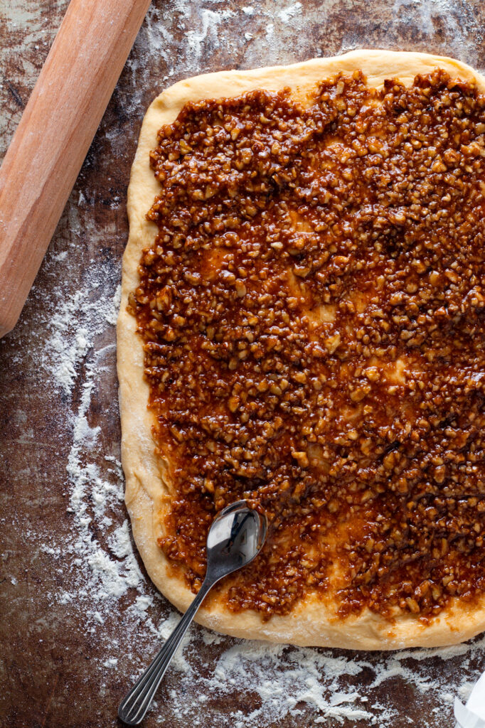 Nut filling spread on dough for Nusszopf.