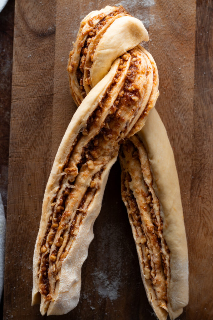 Nut filling spread on dough for Nusszopf, braiding the dough.