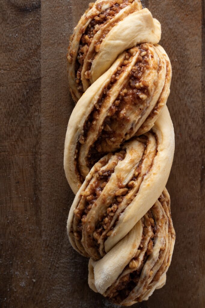 Braided unbaked walnut loaf.