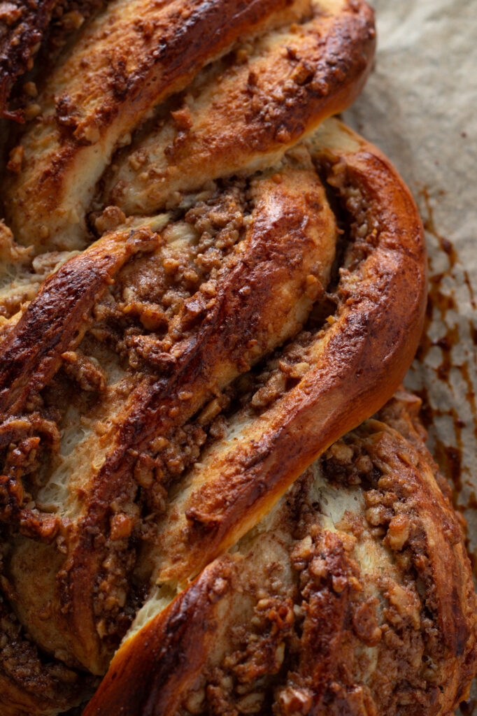 Braided baked walnut loaf close up.