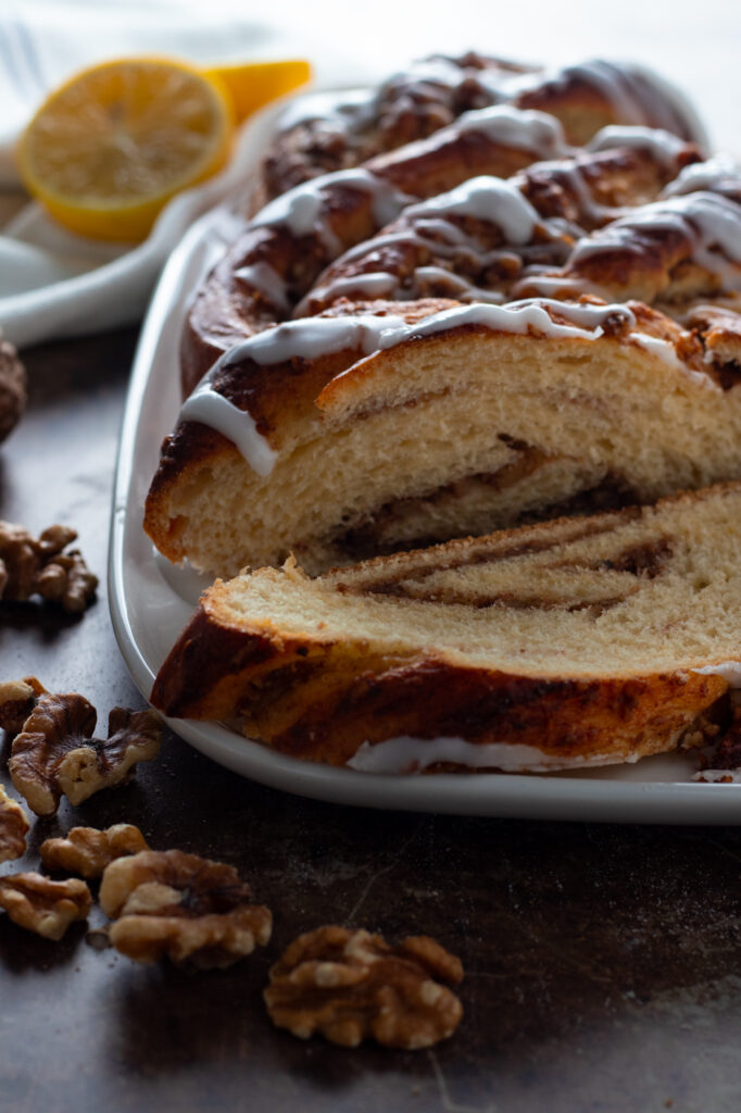 A sliced and glazed German Braided walnut Loaf or Nusszopf.