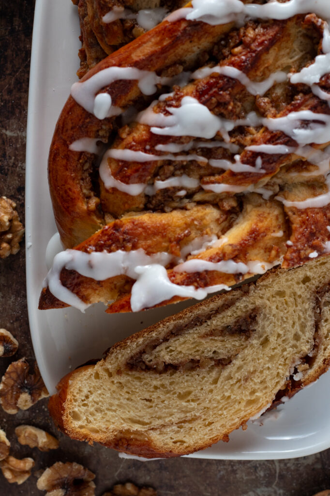 A sliced and glazed German Braided walnut Loaf or Nusszopf.