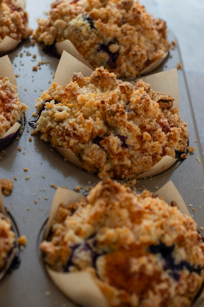 Baked blueberry streusel muffins showing golden brown streusel.