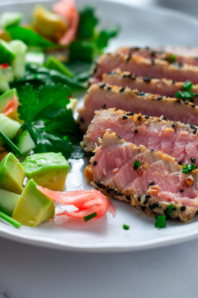 Sesame Crusted Tuna Tataki with asian style salad on a plate.